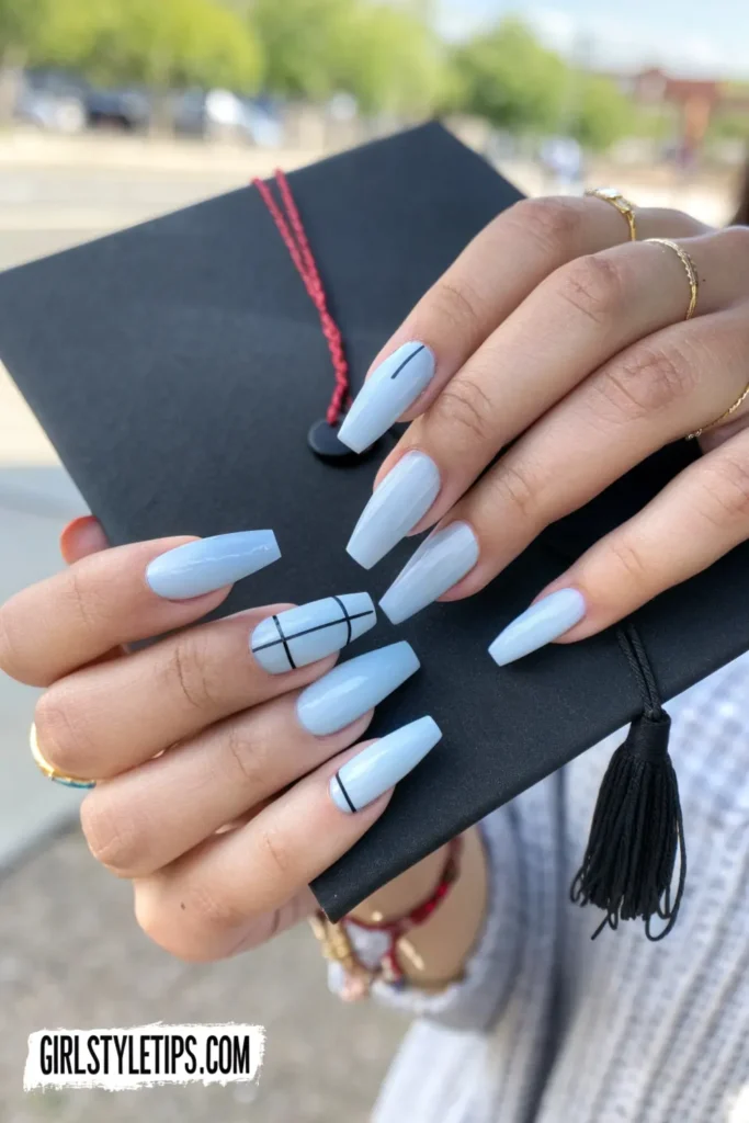 Quote graduation nails with inspirational words in black on pale blue manicure