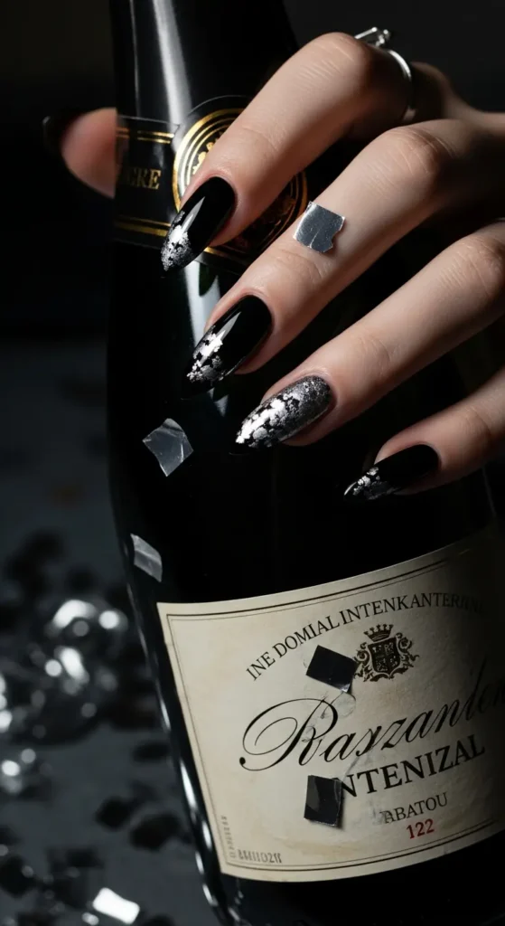 Black nails with silver foil design for New Year's Eve party