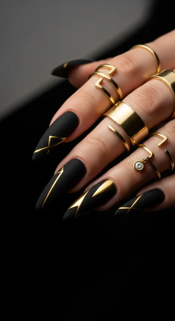Matte black and gold New Year's Eve nails with geometric design